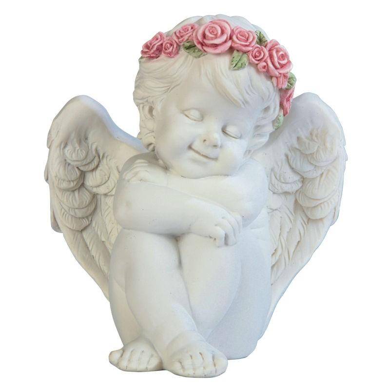 cherub figurine hugging himself cherub figurine hugging himself